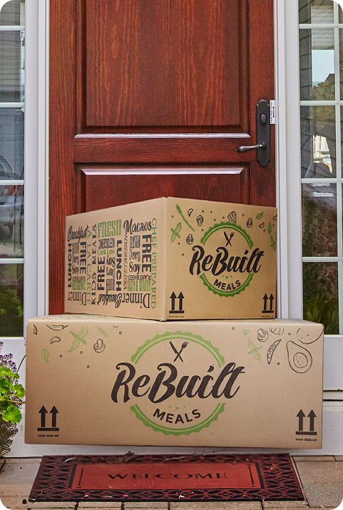 A branded ReBuilt meal delivery box arriving fresh at a customer's doorstep